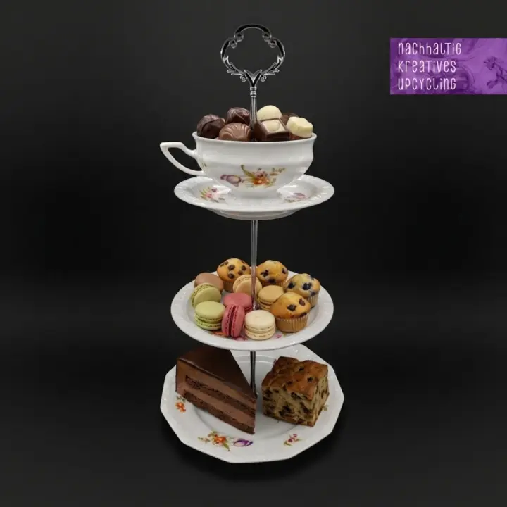 Zweistufige Etagere mit schwarzem Metallgriff, weißem Teller mit Goldrand und goldener Schale